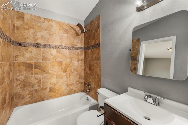 full bathroom with vanity, toilet, tiled shower / bath combo, and vaulted ceiling