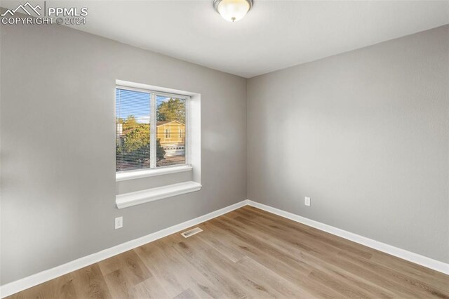 empty room with light hardwood / wood-style flooring