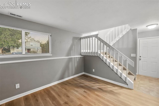 stairs with hardwood / wood-style flooring