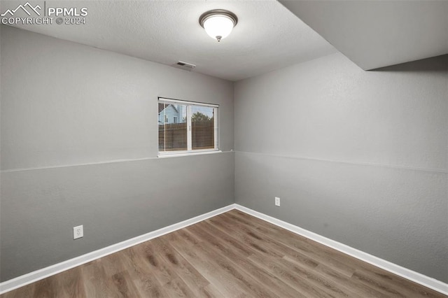 spare room with wood-type flooring