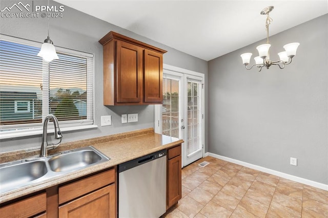 kitchen featuring stainless steel dishwasher, a notable chandelier, sink, and hanging light fixtures