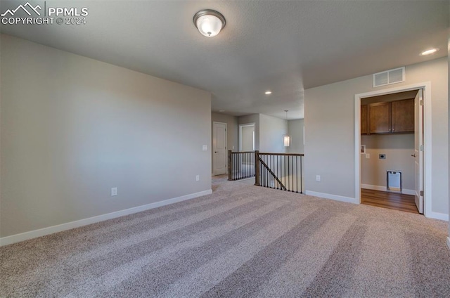 unfurnished bedroom with light colored carpet