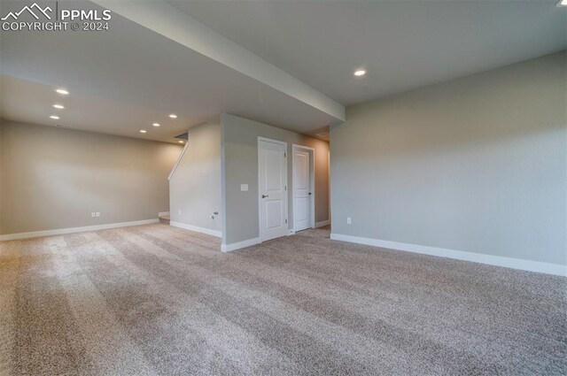 unfurnished room with light carpet