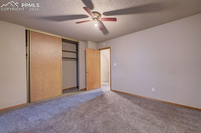 unfurnished bedroom featuring a textured ceiling, ceiling fan, a closet, and carpet flooring