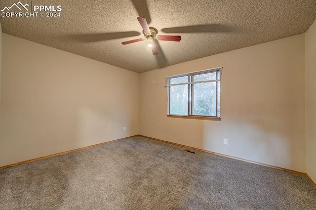 empty room featuring visible vents, a ceiling fan, carpet flooring, a textured ceiling, and baseboards