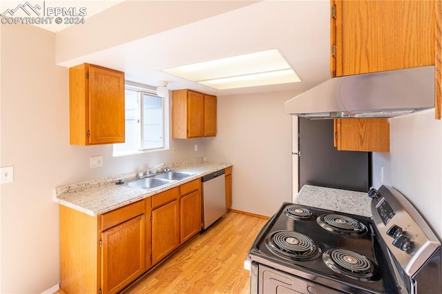 kitchen featuring stainless steel appliances, light hardwood / wood-style floors, extractor fan, and sink