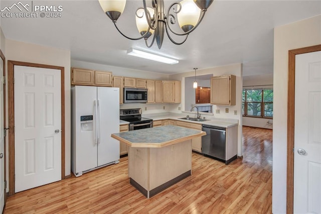 kitchen featuring a kitchen island, decorative light fixtures, a notable chandelier, appliances with stainless steel finishes, and light hardwood / wood-style floors