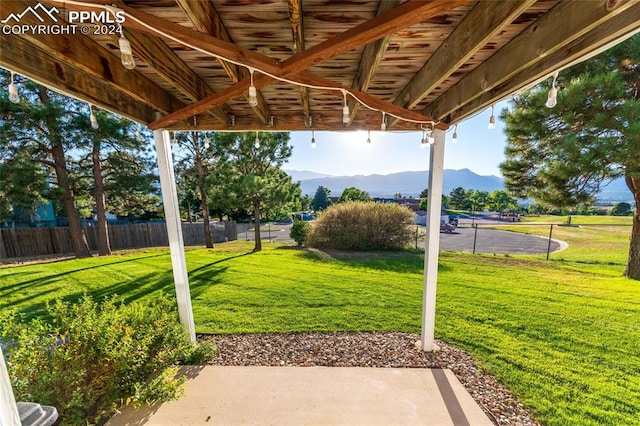 view of yard featuring a mountain view and a patio area