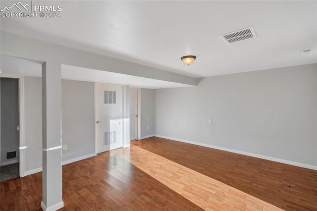 unfurnished room featuring dark hardwood / wood-style flooring