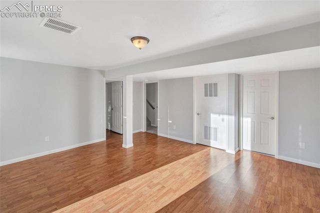 spare room featuring wood-type flooring