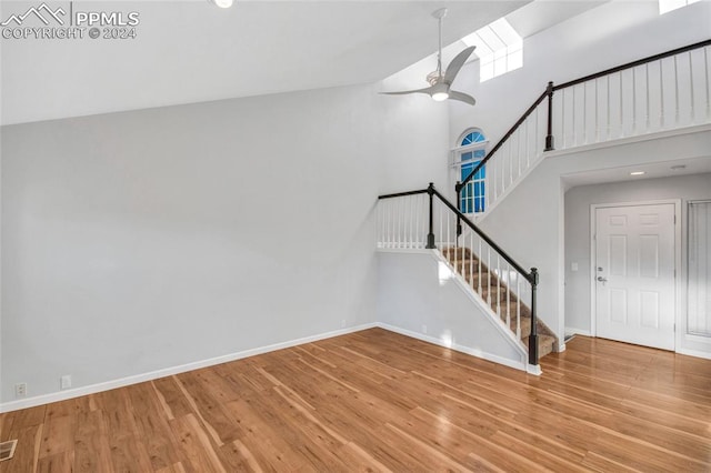 interior space featuring wood-type flooring, high vaulted ceiling, and ceiling fan