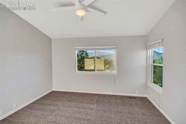 empty room with carpet, vaulted ceiling, and ceiling fan