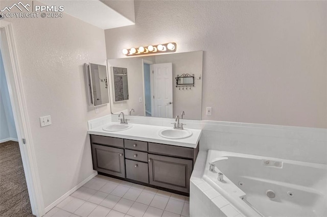 bathroom featuring vanity, tiled bath, and tile patterned floors