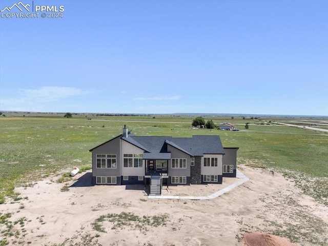 view of front of house with a rural view