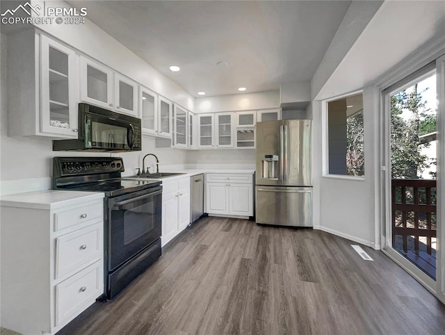 kitchen featuring sink, white cabinetry, black appliances, and dark hardwood / wood-style floors