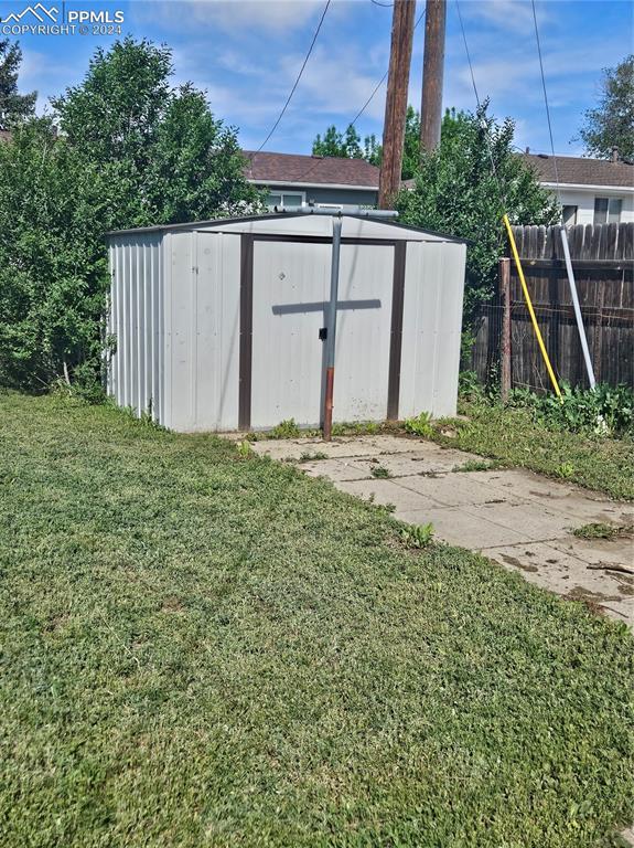 view of shed featuring fence