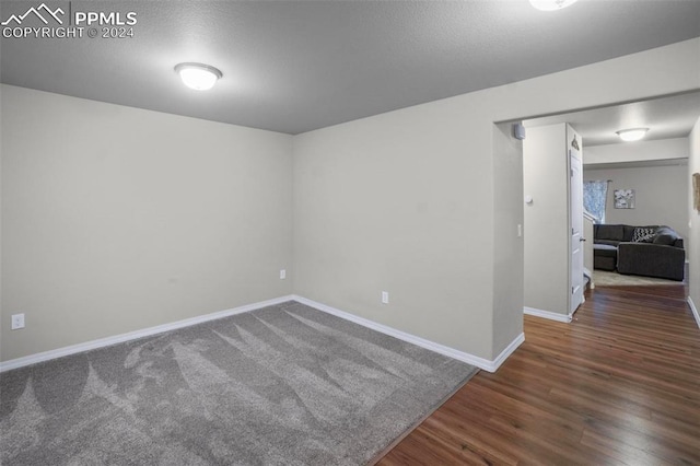 empty room with hardwood / wood-style flooring