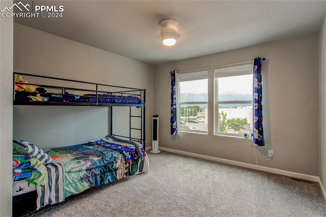 bedroom featuring ceiling fan and carpet