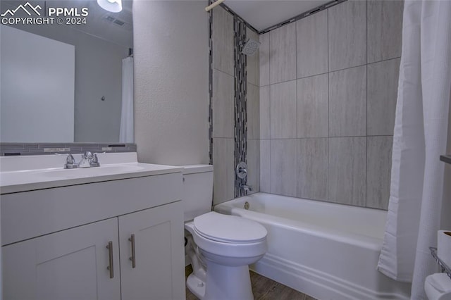 full bathroom with shower / bath combination with curtain, toilet, vanity, and hardwood / wood-style flooring