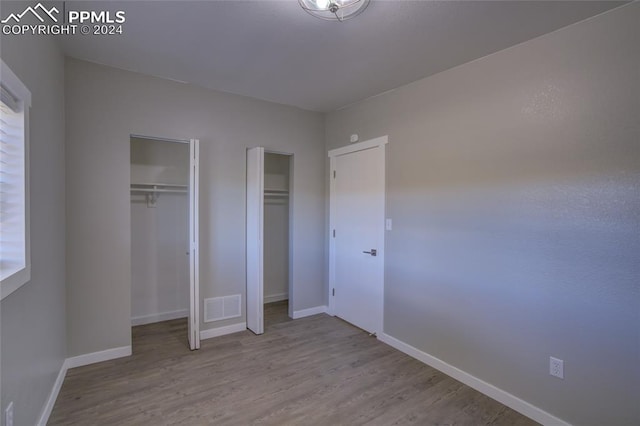 unfurnished bedroom featuring hardwood / wood-style flooring