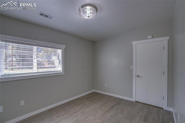 spare room featuring hardwood / wood-style floors