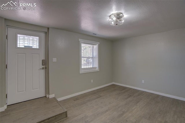 foyer featuring a textured ceiling and hardwood / wood-style floors