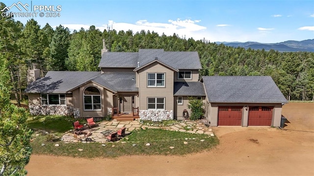 view of front of property with a garage and a mountain view