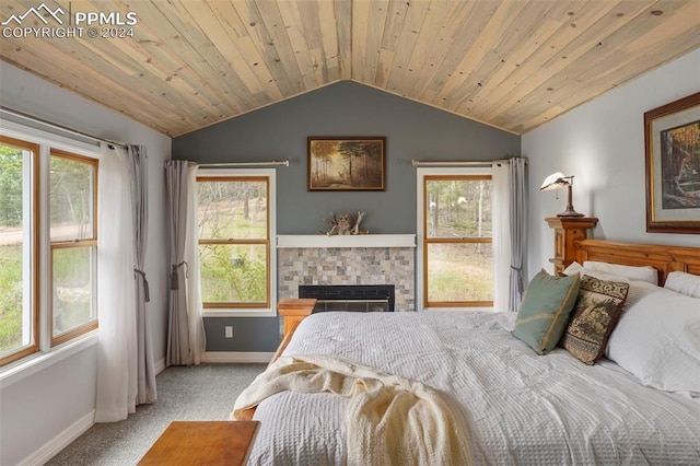 bedroom with wooden ceiling, vaulted ceiling, and light colored carpet