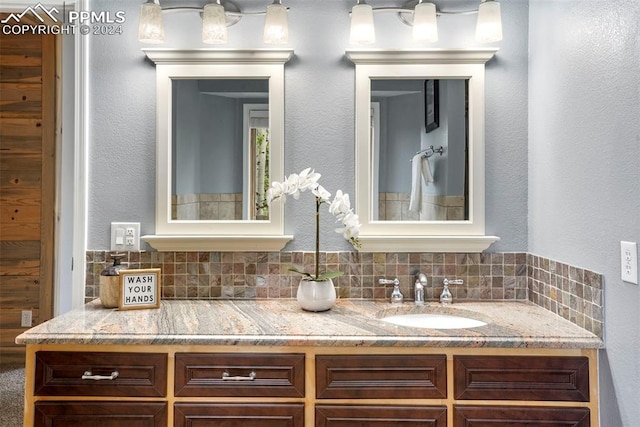 bathroom featuring tasteful backsplash and vanity