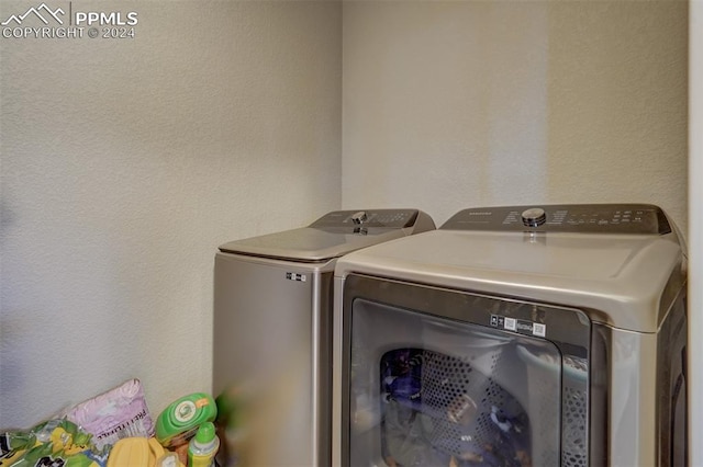 clothes washing area featuring independent washer and dryer