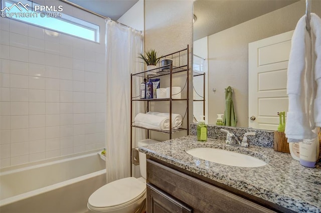 full bathroom featuring vanity, shower / tub combo with curtain, and toilet