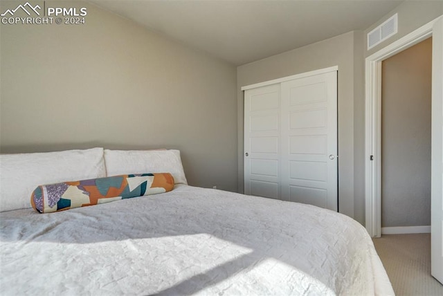 carpeted bedroom with a closet