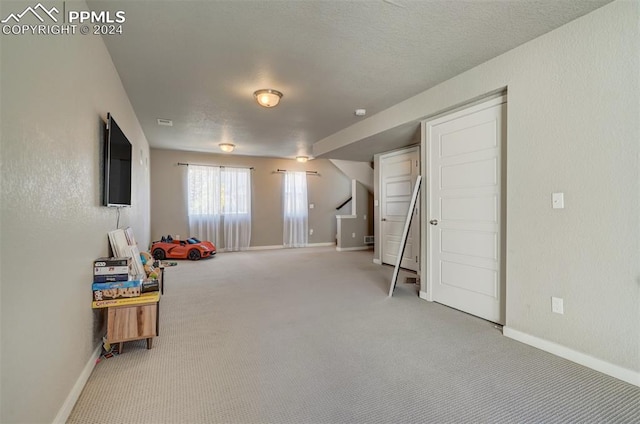 playroom featuring light colored carpet