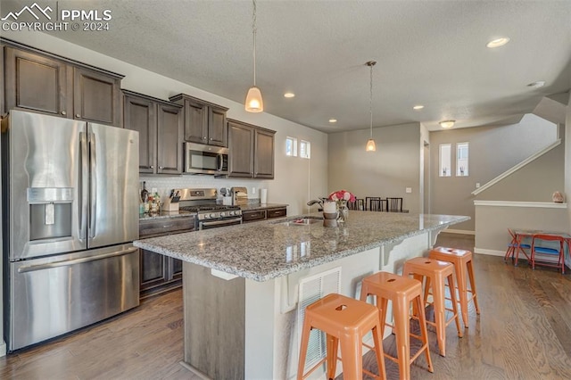 kitchen featuring appliances with stainless steel finishes, light hardwood / wood-style floors, and a wealth of natural light