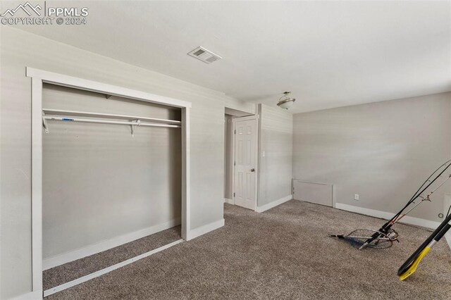 unfurnished bedroom featuring a closet and carpet floors