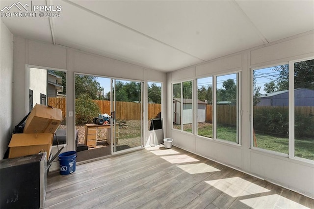 unfurnished sunroom with lofted ceiling