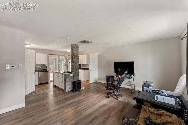 interior space featuring dark hardwood / wood-style floors and ornate columns