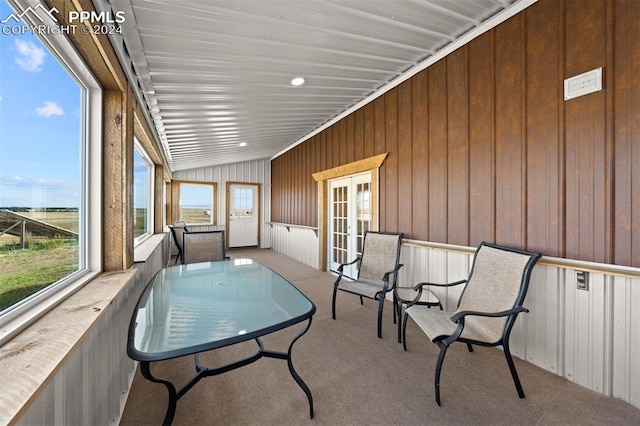 sunroom featuring vaulted ceiling