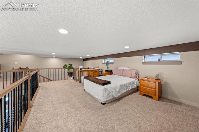 bedroom featuring carpet and a textured ceiling