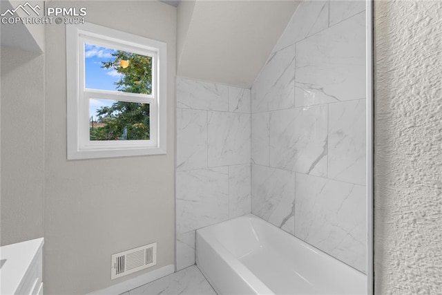 bathroom with tile patterned floors, vanity, and tiled shower / bath