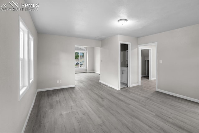 unfurnished room with hardwood / wood-style floors