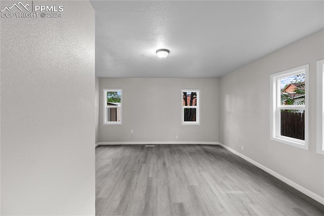 unfurnished room featuring wood-type flooring