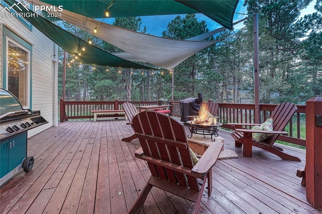 wooden deck with a fire pit