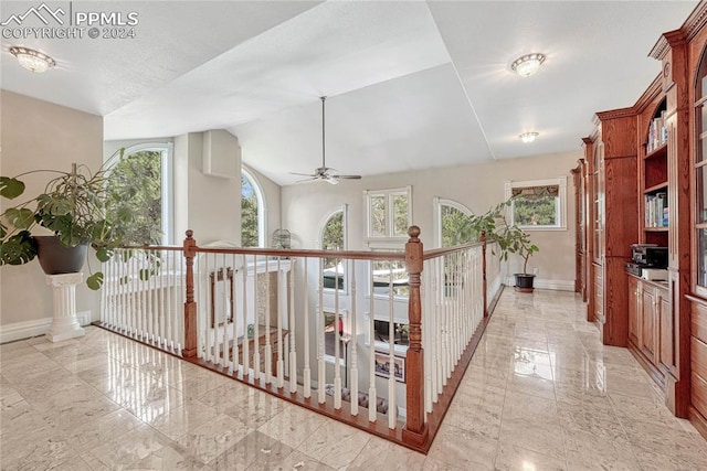 hall featuring vaulted ceiling