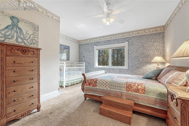 carpeted bedroom featuring ceiling fan and ornamental molding