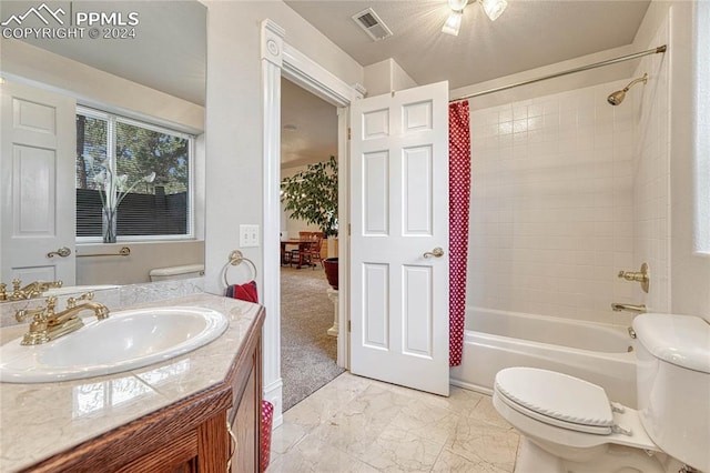 full bathroom with tiled shower / bath, toilet, and vanity