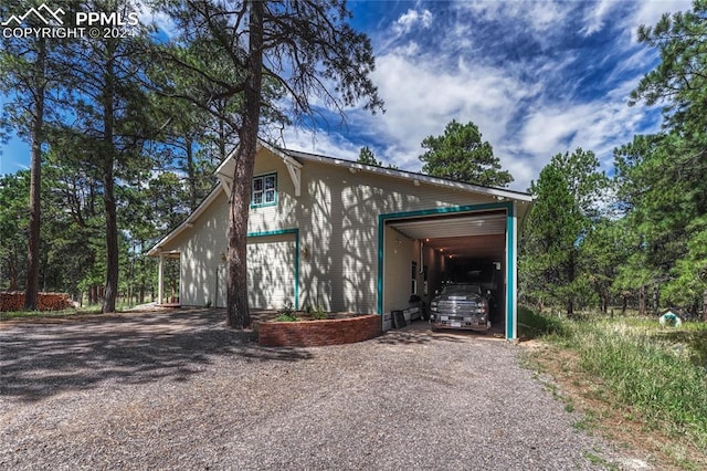 view of property exterior featuring a garage and a carport