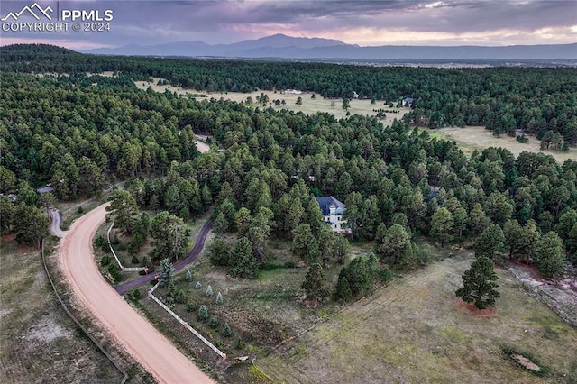 aerial view at dusk featuring a mountain view