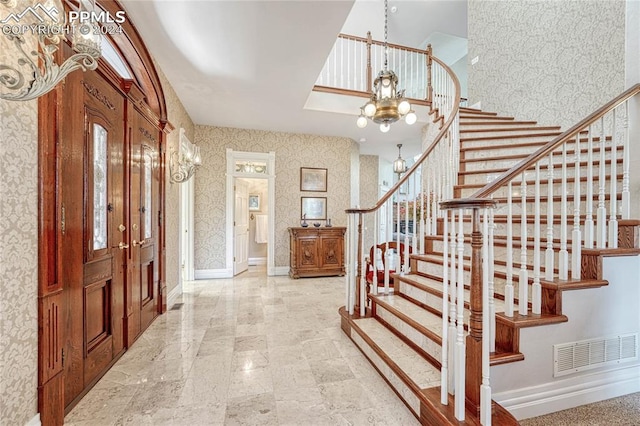 foyer entrance with a chandelier