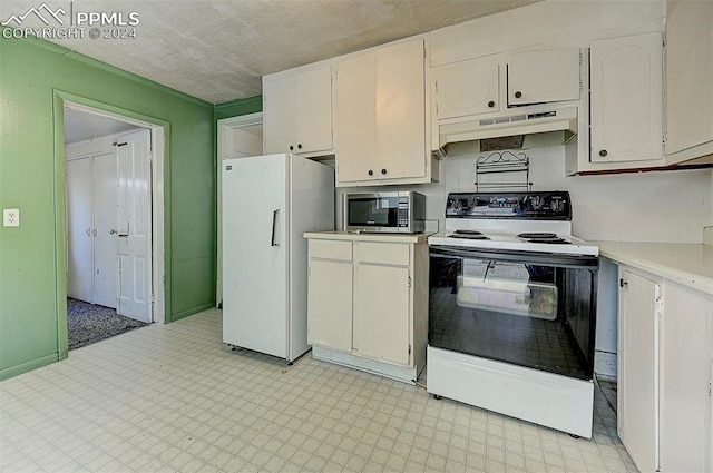 kitchen featuring range with electric cooktop, stainless steel microwave, light floors, freestanding refrigerator, and under cabinet range hood